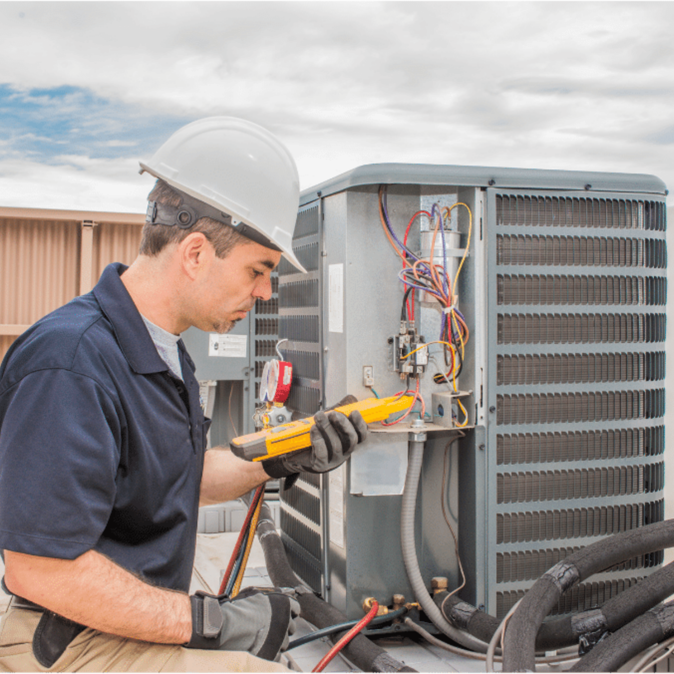 Woodstock Heating & Cooling HVAC technician servicing a system